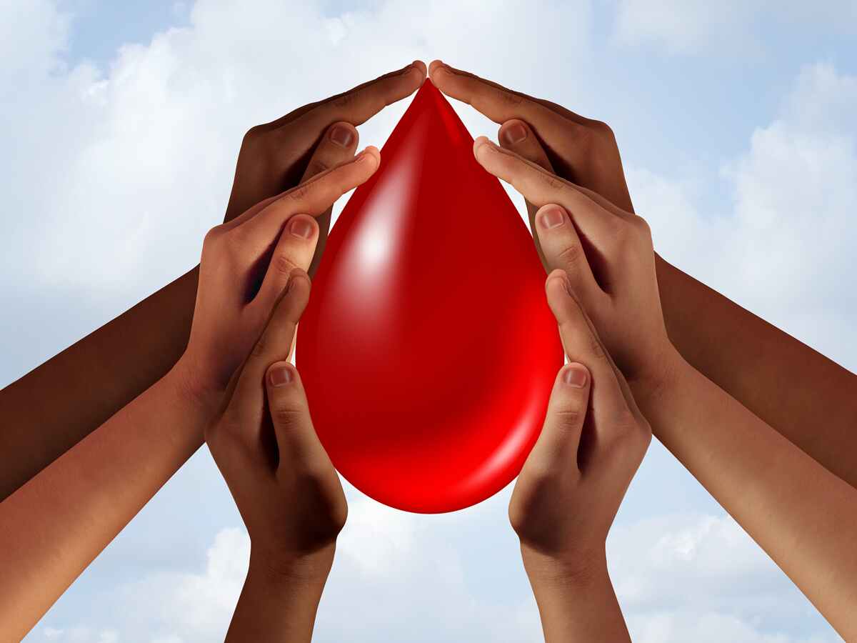 hands holding large blood drop