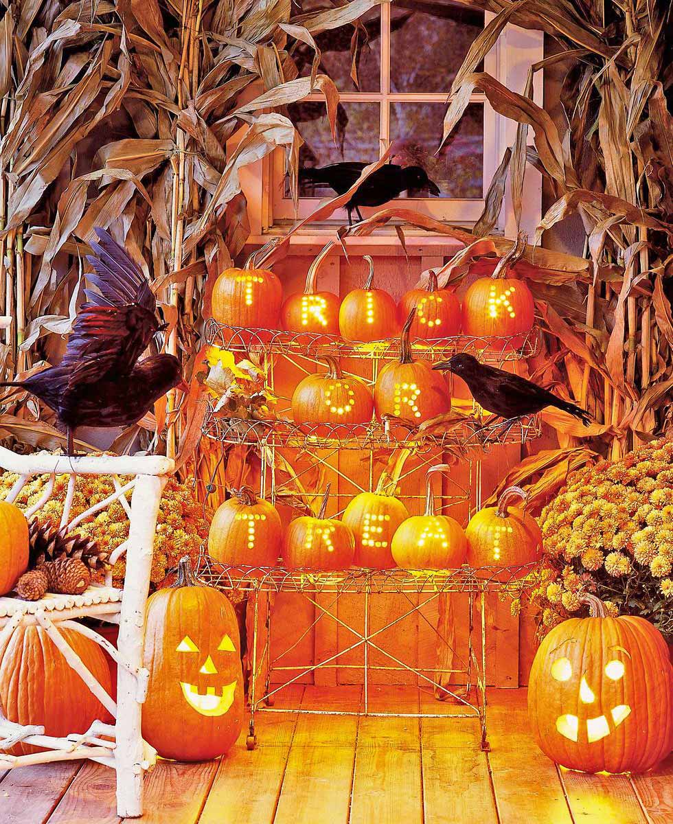 Halloween porch decorations featuring pumpkins, corn and crows