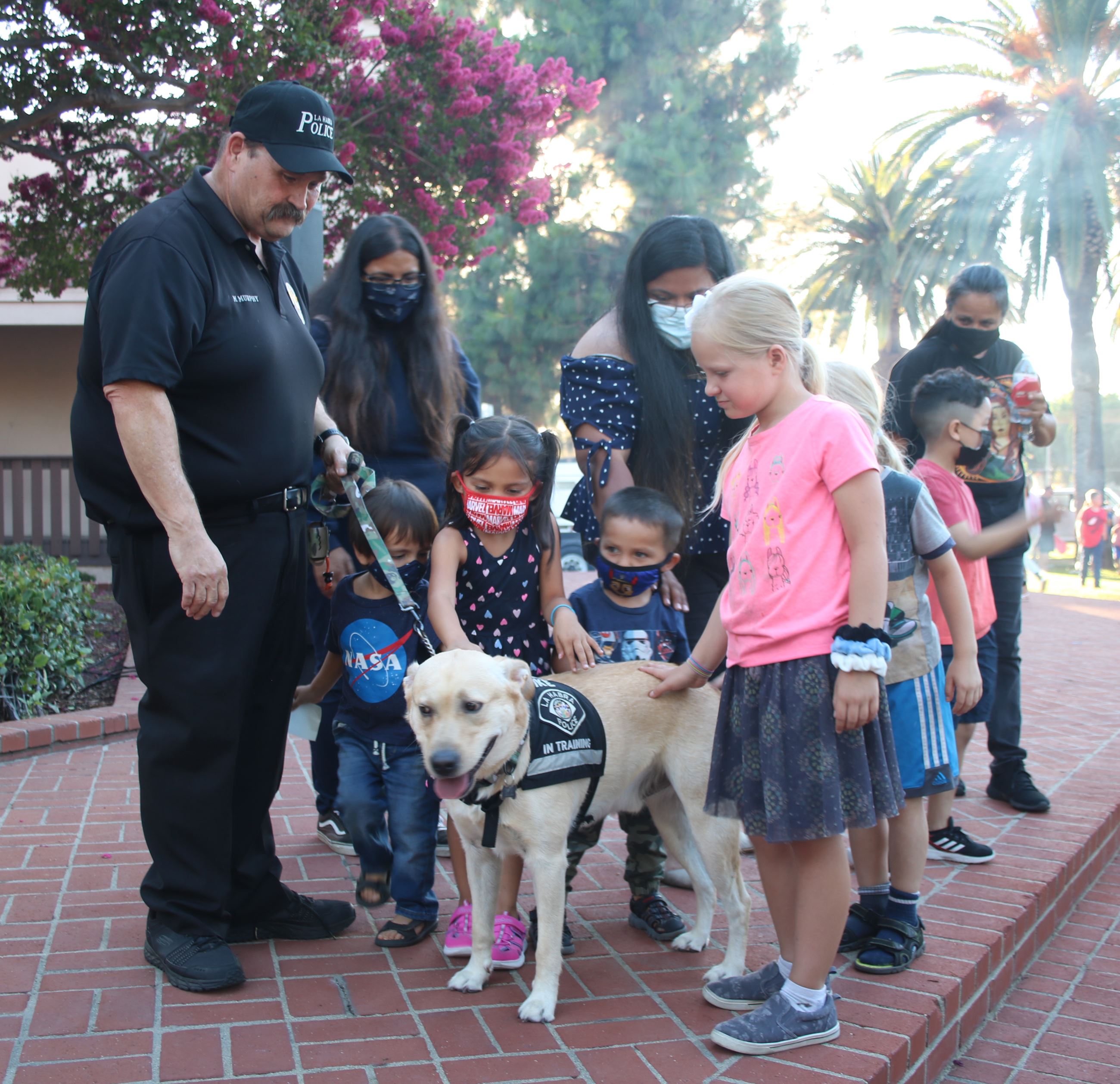 police chaplain mike with therapy dog and kids